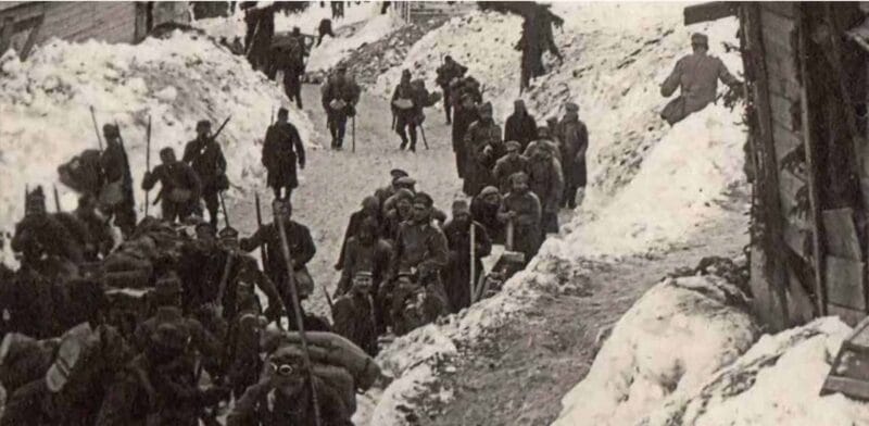 Prisoners of war and Austro-Hungarian soldiers passing by warehouses and a field hospital near the Voss Hut, the present-day Erjavčeva Koča.